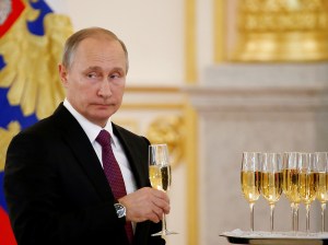 Russia's President Putin holds a glass during a ceremony of receiving diplomatic credentials from foreign ambassadors at the Kremlin in Moscow